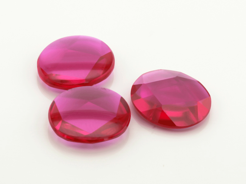 Synthetic/Lab Grown Ruby 12x10mm Oval Buff Top Faceted Back Bright Red
